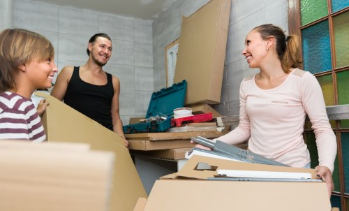 Professional team handling upright piano removals in a Surrey home