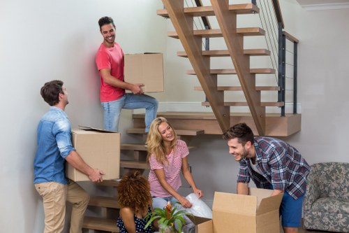Movers handling desks and equipment in a Surrey office move