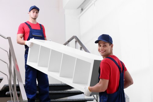 Team using lifting equipment to handle heavy furniture safely