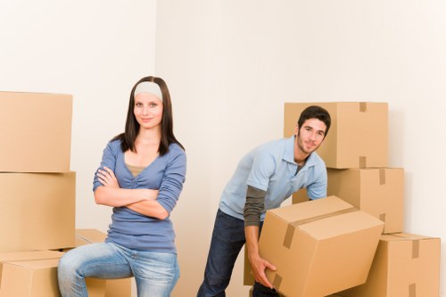 Professional movers carrying furniture and boxes during a Surrey relocation